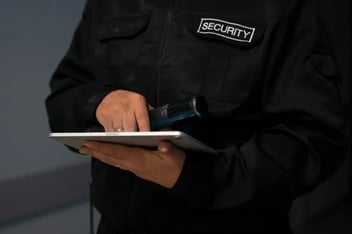 Security guard working on tablet device