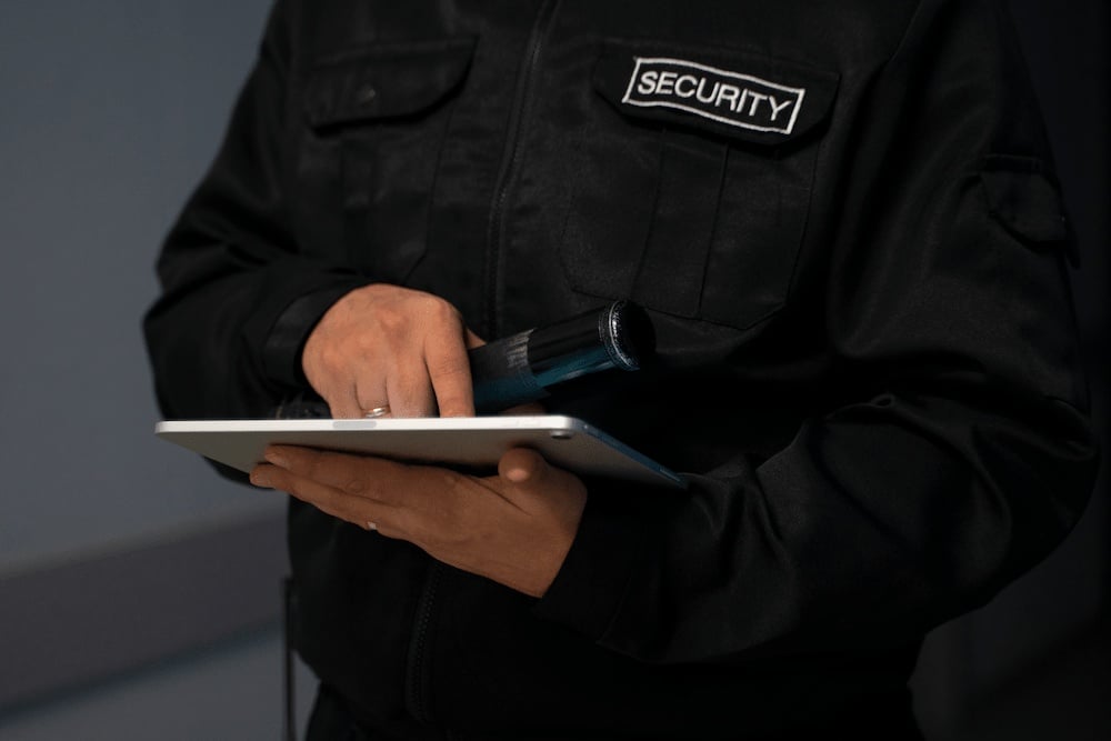 Security guard working on tablet device